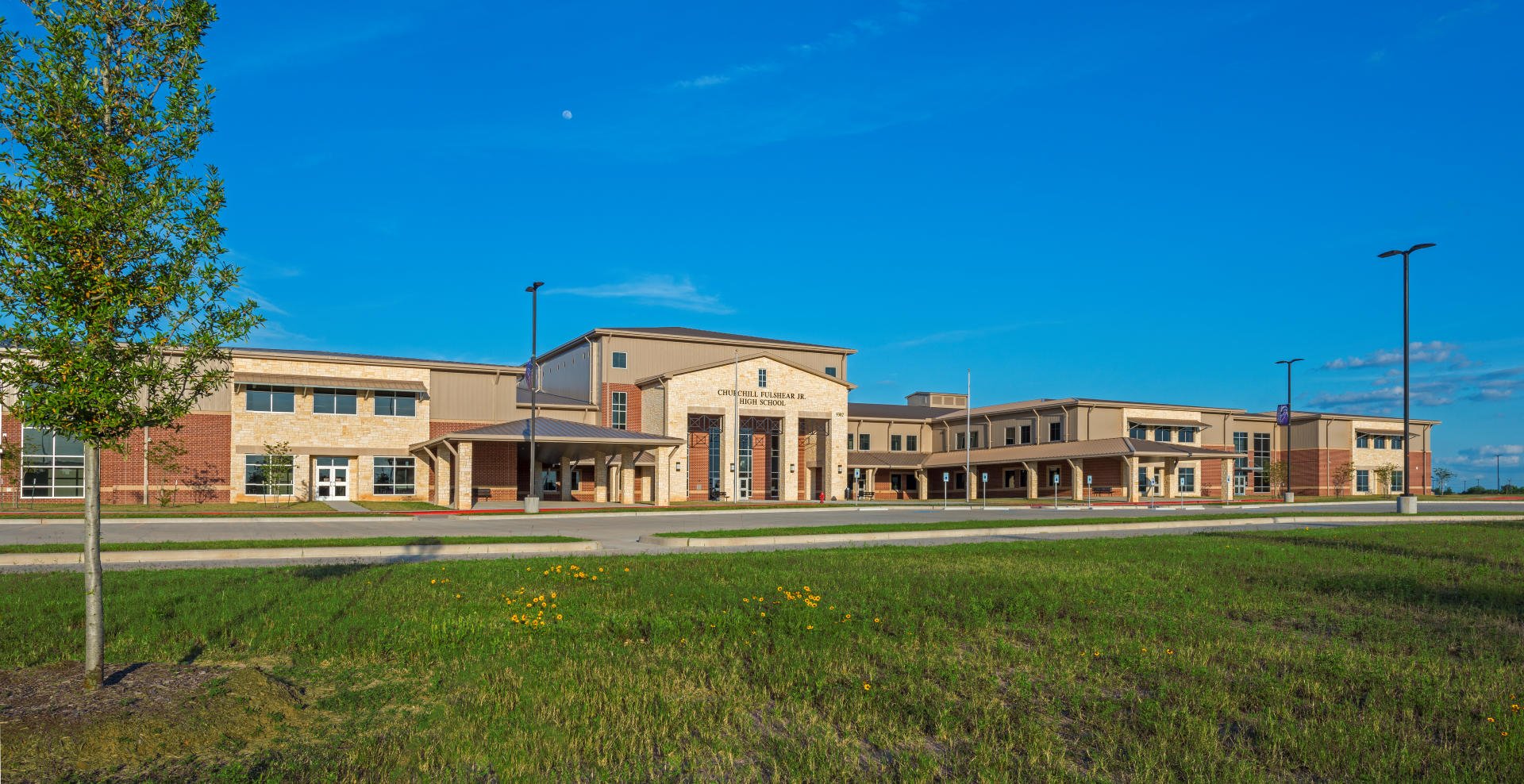 Lamar Consolidated ISD – Churchill Fulshear Jr. - High School & Dean Leaman Junior High SchoolThe Lamar CISD Churchill Fulshear High School and Dean Leaman Junior High School educational complex encompasses a 166 acre site. The approximately 590,000 SF of structures are comprised of a two-story high school, two-story junior high school, a single story athletic field house, single story transportation building, concession stands and ticket booths. Other elements include a competition football field, running track and field events, several football/soccer practice fields, baseball field, softball field, tennis courts, detention pond and extensive concrete paving. All structures are covered with standing seam metal roofing and include striking architectural features such as natural stone accents and expansive main street corridors. Back to Portfolio